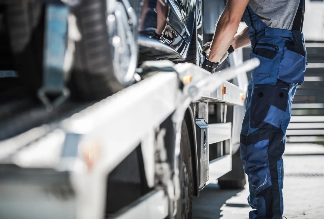Vancouver tow truck driver loading a car onto a flatbed
